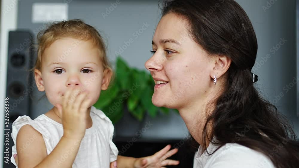 Little girl kiss happy laughing mum at home. Mother day or birthday. Love and tenderness. Little girl kiss happy laughing mum at home. Mother day or birthday. Love and tenderness.