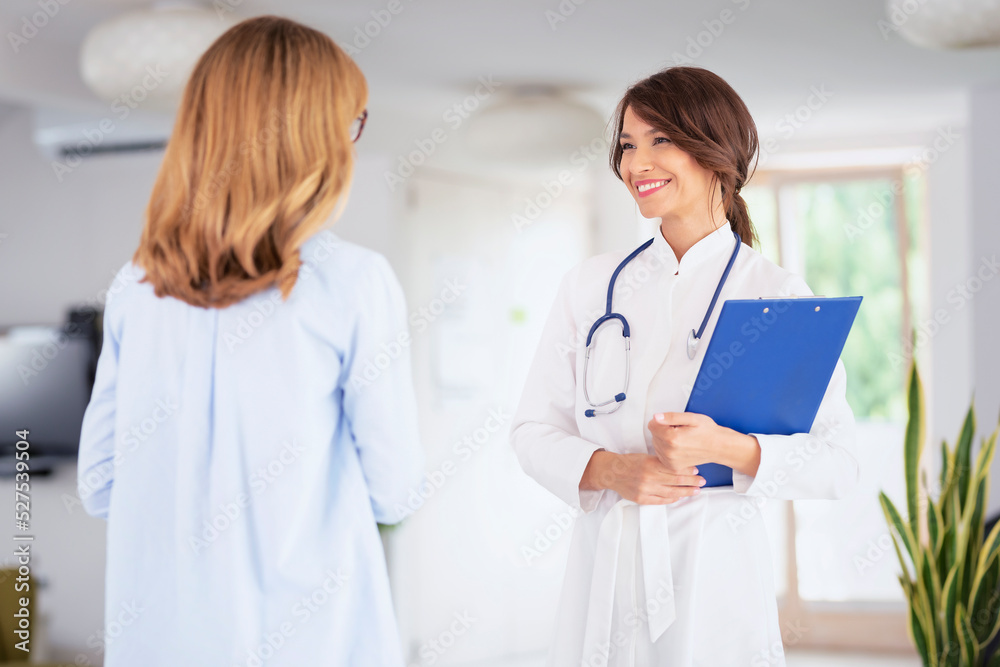 Female doctor consulting with her patient at doctor's office Female doctor consulting with her patient at doctor's office
