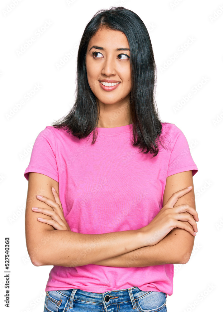 Beautiful asian young woman wearing casual pink t shirt smiling looking to the side and staring away thinking. Beautiful asian young woman wearing casual pink t shirt smiling looking to the side and staring away thinking.