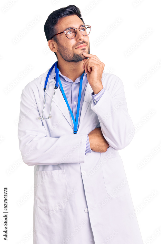 Young hispanic man wearing doctor uniform and stethoscope with hand on chin thinking about question, pensive expression. smiling and thoughtful face. doubt concept. Young hispanic man wearing doctor uniform and stethoscope with hand on chin thinking about question, pensive expression. smiling and thoughtful face. doubt concept.