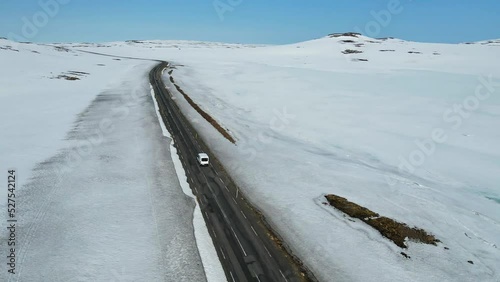 Aerial shot of a van driving on a road in Iceland