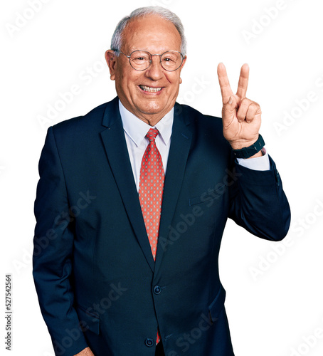 Senior man with grey hair wearing business suit and glasses showing and pointing up with fingers number two while smiling confident and happy. photo