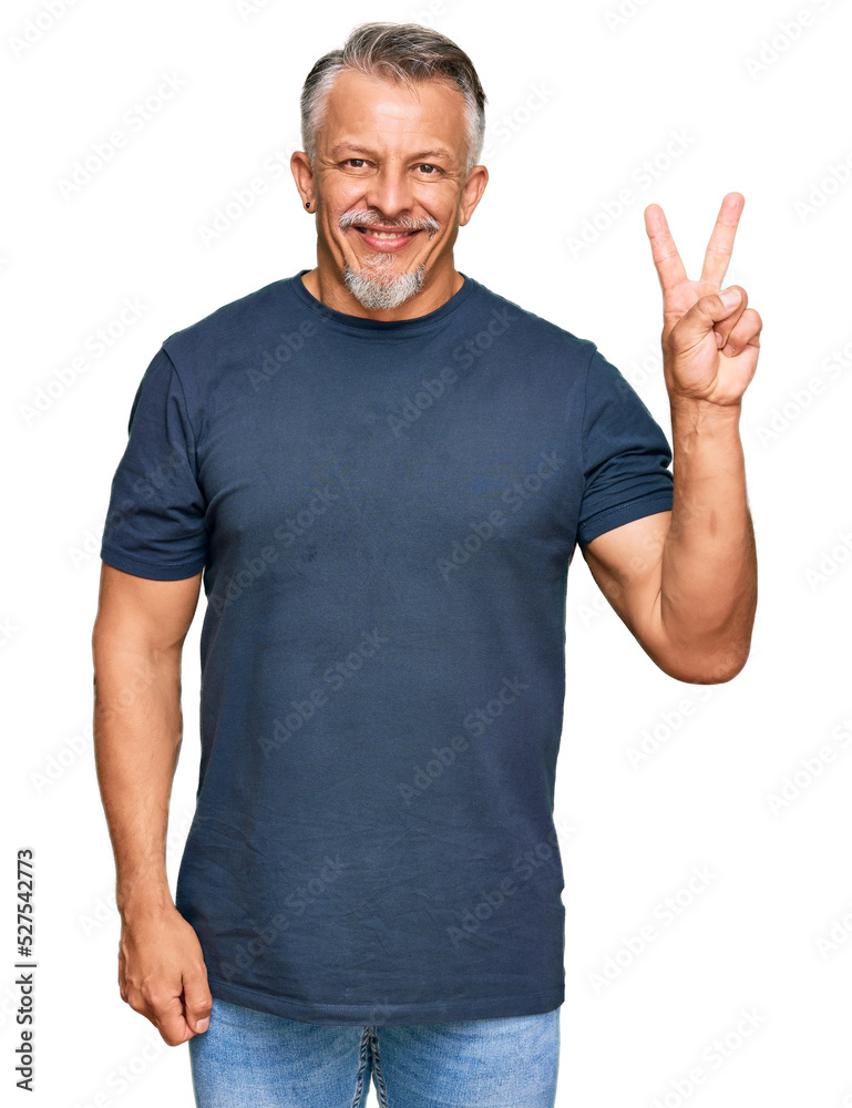 Middle age grey-haired man wearing casual clothes showing and pointing up with fingers number two while smiling confident and happy. Middle age grey-haired man wearing casual clothes showing and pointing up with fingers number two while smiling confident and happy.