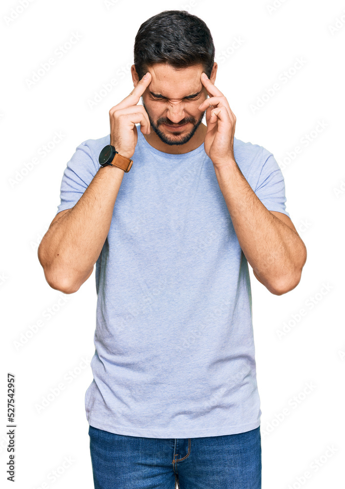 Young hispanic man wearing casual clothes with hand on head, headache because stress. suffering migraine. Young hispanic man wearing casual clothes with hand on head, headache because stress. suffering migraine.