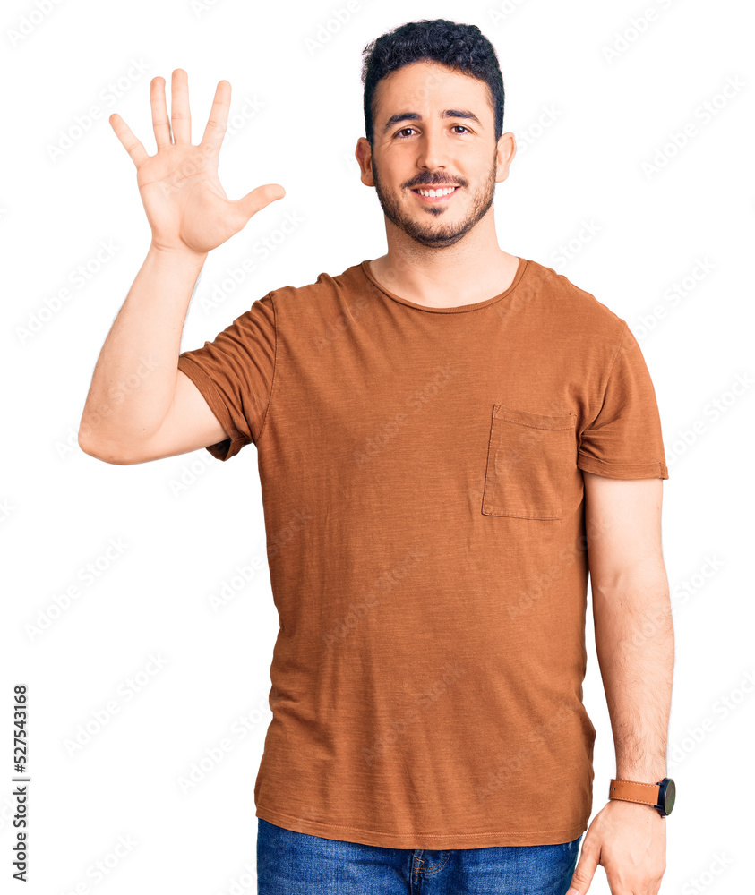 Young hispanic man wearing casual clothes showing and pointing up with fingers number five while smiling confident and happy. Young hispanic man wearing casual clothes showing and pointing up with fingers number five while smiling confident and happy.