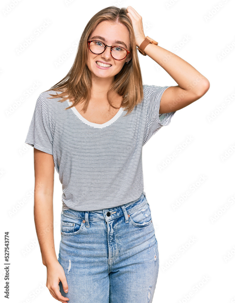 Beautiful young blonde woman wearing casual clothes and glasses confuse and wonder about question. uncertain with doubt, thinking with hand on head. pensive concept.