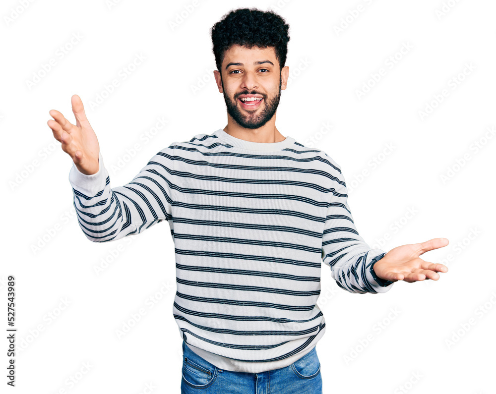 Young arab man with beard wearing casual striped sweater smiling cheerful offering hands giving assistance and acceptance. Young arab man with beard wearing casual striped sweater smiling cheerful offering hands giving assistance and acceptance.