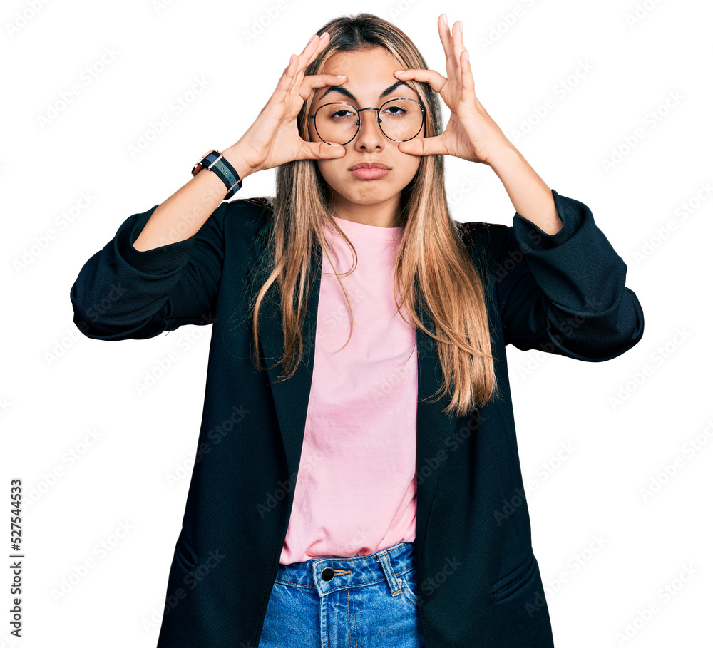 Hispanic young woman wearing business jacket and glasses trying to open eyes with fingers, sleepy and tired for morning fatigue Hispanic young woman wearing business jacket and glasses trying to open eyes with fingers, sleepy and tired for morning fatigue