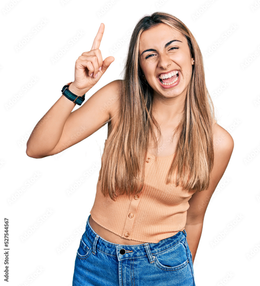 Hispanic young woman wearing casual summer shirt pointing finger up with successful idea. exited and happy. number one. Hispanic young woman wearing casual summer shirt pointing finger up with successful idea. exited and happy. number one.