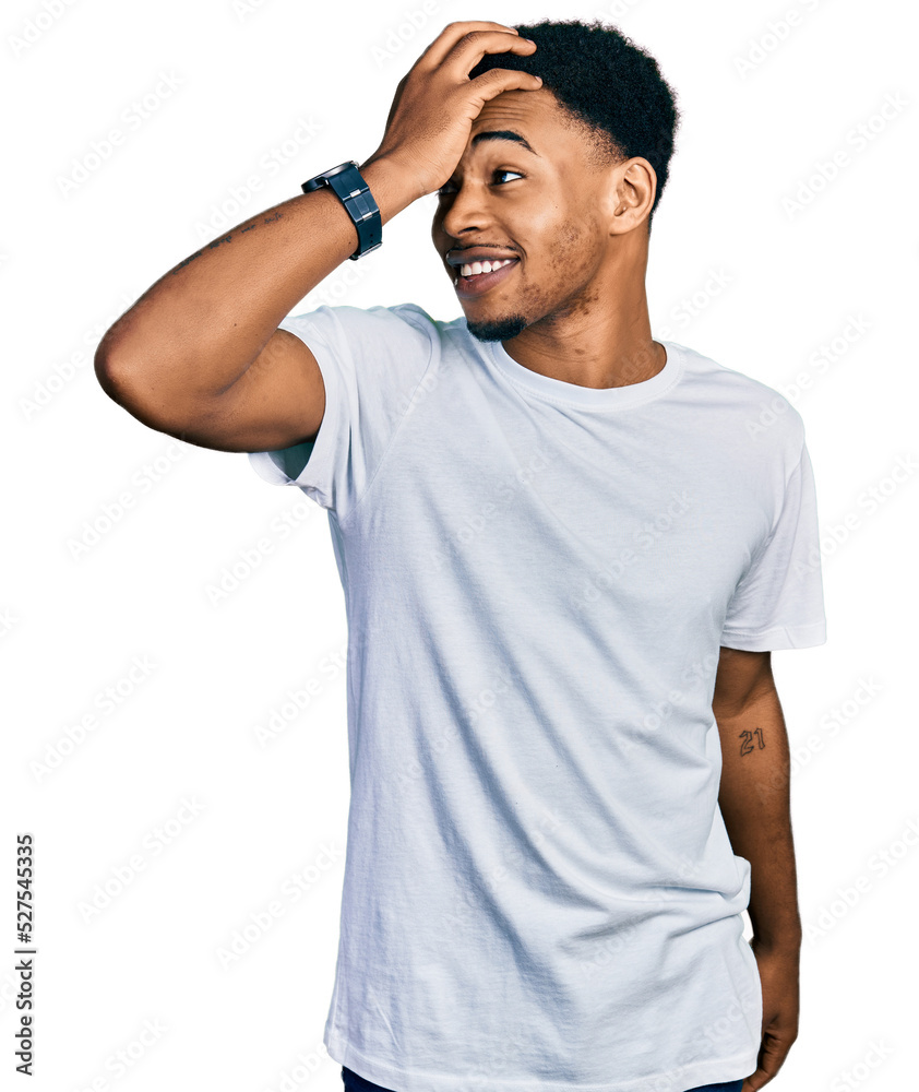 Young african american man wearing casual white t shirt smiling confident touching hair with hand up gesture, posing attractive and fashionable
