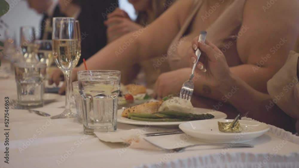 People eating food at dinner. People eating food at dinner.