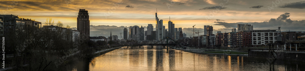 Frankfurt skyline at sunset panorama wide view from bridge over main river