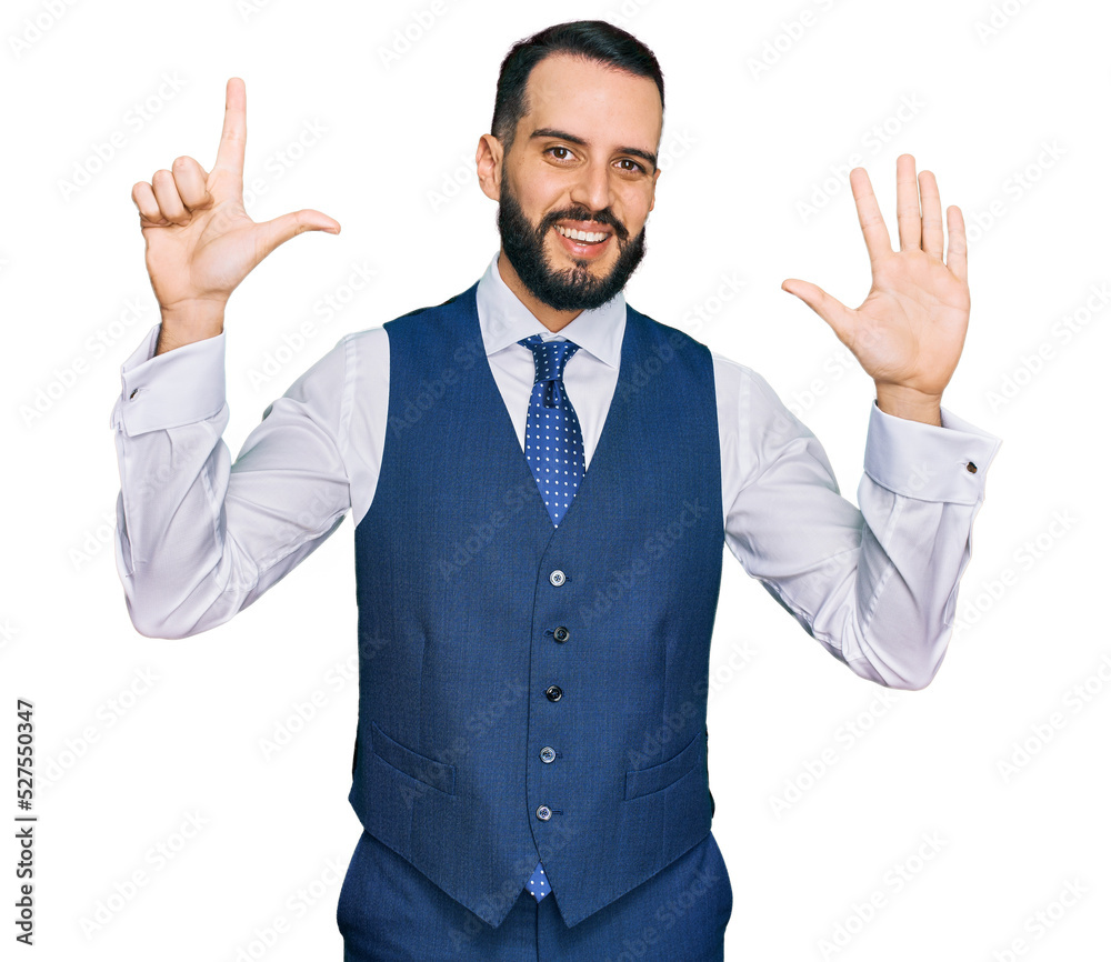 Young man with beard wearing business vest showing and pointing up with fingers number seven while smiling confident and happy. Young man with beard wearing business vest showing and pointing up with fingers number seven while smiling confident and happy.