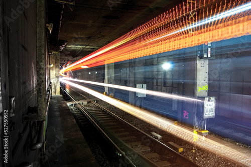 Long Exposure train passing by from tunnel into station with blurred lights