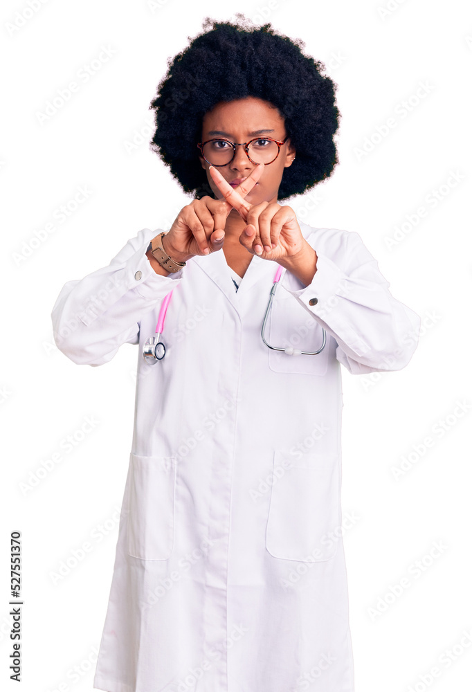 Young african american woman wearing doctor coat and stethoscope rejection expression crossing fingers doing negative sign Young african american woman wearing doctor coat and stethoscope rejection expression crossing fingers doing negative sign