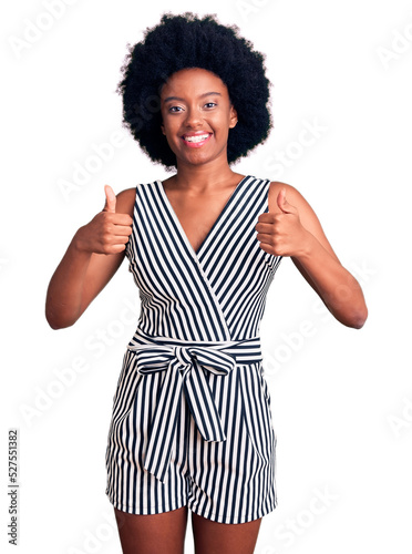 Young african american woman wearing casual clothes success sign doing positive gesture with hand, thumbs up smiling and happy. cheerful expression and winner gesture.