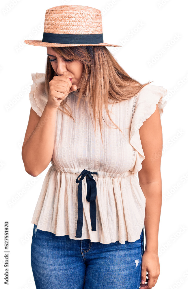Young beautiful woman wearing summer hat and t-shirt feeling unwell and coughing as symptom for cold or bronchitis. health care concept. Young beautiful woman wearing summer hat and t-shirt feeling unwell and coughing as symptom for cold or bronchitis. health care concept.