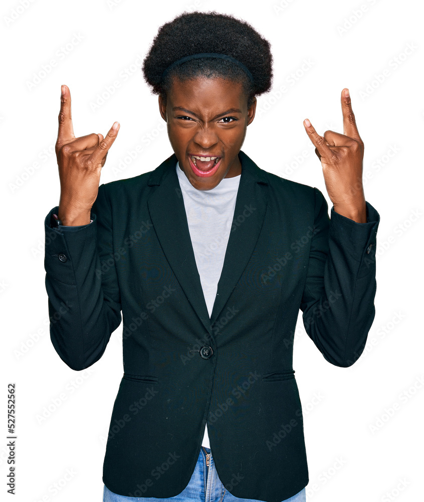 Young african american girl wearing business clothes shouting with crazy expression doing rock symbol with hands up. music star. heavy music concept. Young african american girl wearing business clothes shouting with crazy expression doing rock symbol with hands up. music star. heavy music concept.