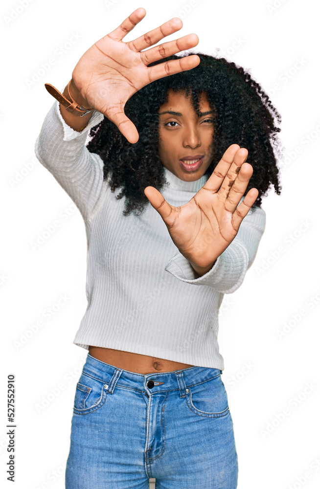 Young african american girl wearing casual clothes doing frame using hands palms and fingers, camera perspective Young african american girl wearing casual clothes doing frame using hands palms and fingers, camera perspective