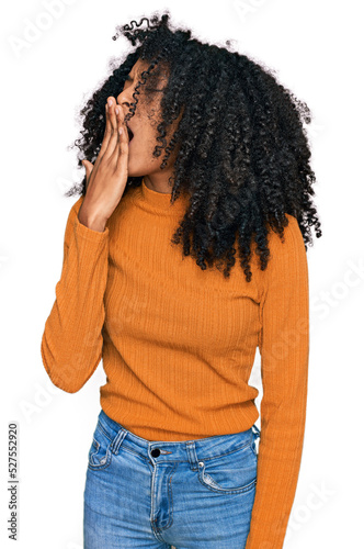 Young african american girl wearing casual clothes bored yawning tired covering mouth with hand. restless and sleepiness.