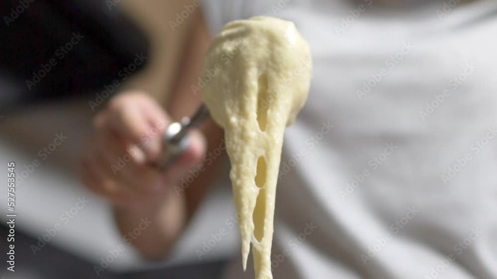 A female whisk some eggs and flour until they become dough for making pancakes, slow motion, home cooking A female whisk some eggs and flour until they become dough for making pancakes, slow motion, home cooking