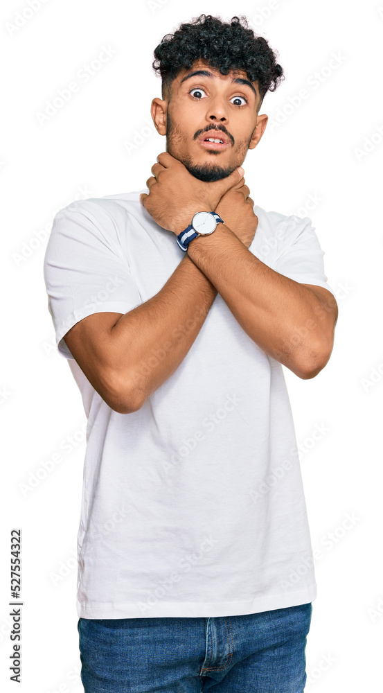 Young arab man wearing casual white t shirt shouting suffocate because painful strangle. health problem. asphyxiate and suicide concept. Young arab man wearing casual white t shirt shouting suffocate because painful strangle. health problem. asphyxiate and suicide concept.