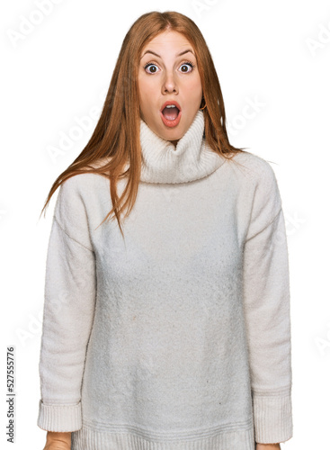 Young irish woman wearing casual winter sweater afraid and shocked with surprise and amazed expression, fear and excited face. © Krakenimages.com