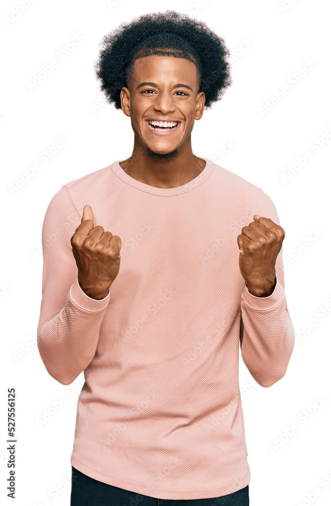 African american man with afro hair wearing casual clothes excited for success with arms raised and eyes closed celebrating victory smiling. winner concept. African american man with afro hair wearing casual clothes excited for success with arms raised and eyes closed celebrating victory smiling. winner concept.
