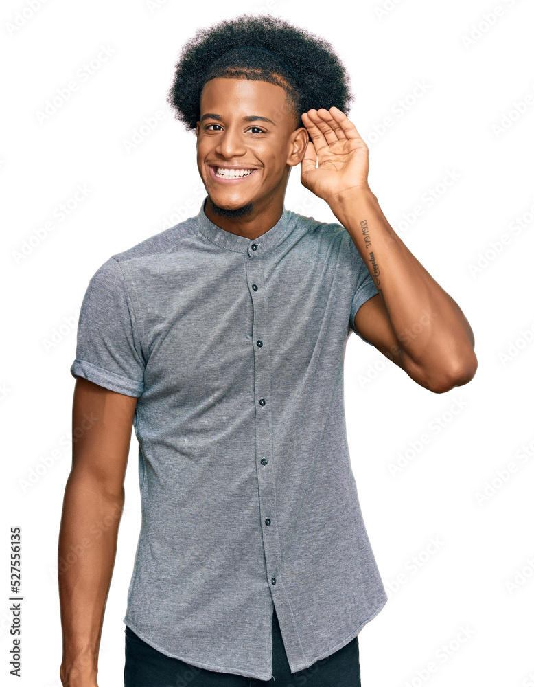 African american man with afro hair wearing casual clothes smiling with hand over ear listening an hearing to rumor or gossip. deafness concept. African american man with afro hair wearing casual clothes smiling with hand over ear listening an hearing to rumor or gossip. deafness concept.