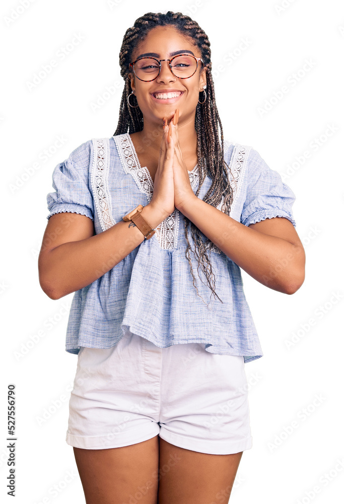 Young african american woman with braids wearing casual summer clothes and glasses praying with hands together asking for forgiveness smiling confident. Young african american woman with braids wearing casual summer clothes and glasses praying with hands together asking for forgiveness smiling confident.