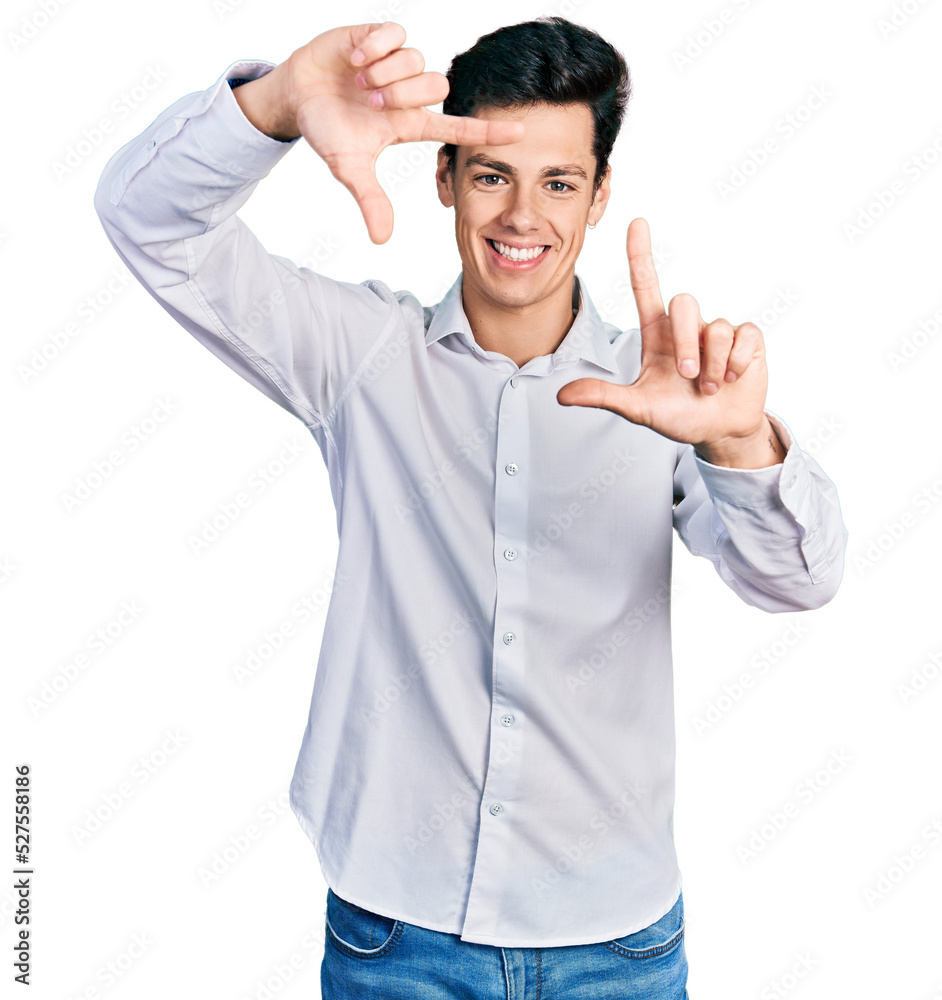 Young hispanic business man wearing business clothes smiling making frame with hands and fingers with happy face. creativity and photography concept.