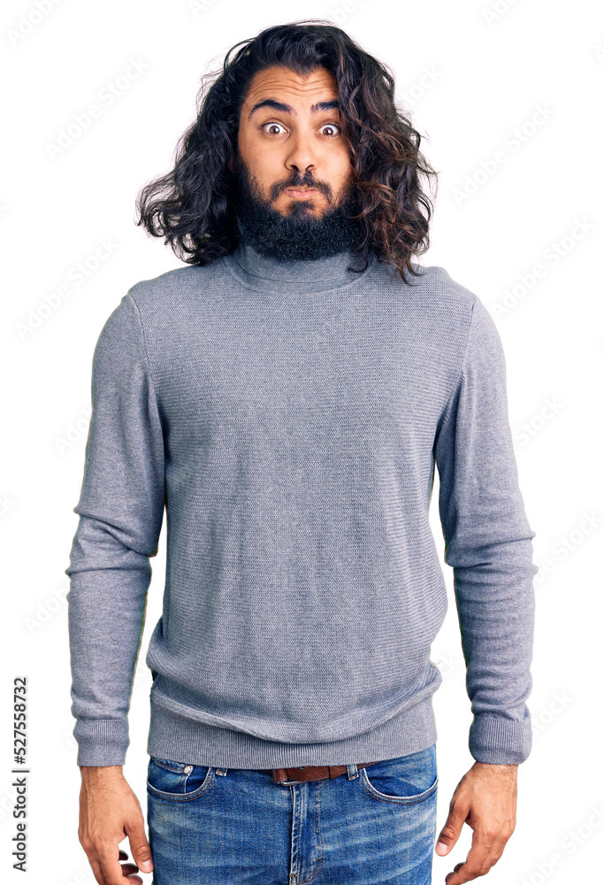 Young arab man wearing casual clothes puffing cheeks with funny face. mouth inflated with air, crazy expression. Young arab man wearing casual clothes puffing cheeks with funny face. mouth inflated with air, crazy expression.