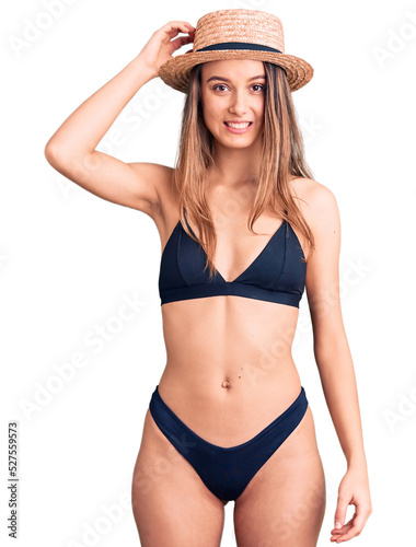 Young beautiful girl wearing bikini and hat confuse and wonder about question. uncertain with doubt, thinking with hand on head. pensive concept.