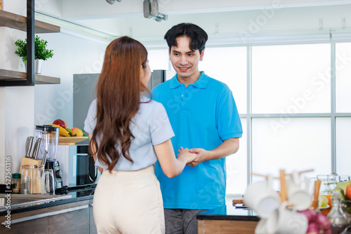 Asian young romantic couple beautiful wife standing smiling with handsome husband behind kitchen counter full of fresh raw organic vegetables