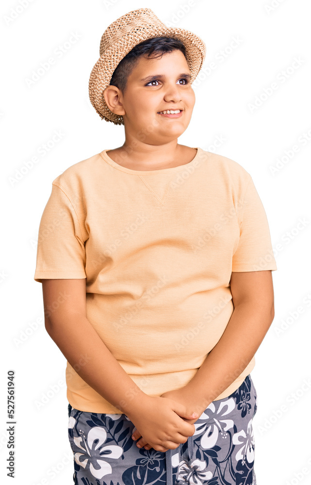 Little boy kid wearing summer hat and hawaiian swimsuit looking away to side with smile on face, natural expression. laughing confident. Little boy kid wearing summer hat and hawaiian swimsuit looking away to side with smile on face, natural expression. laughing confident.