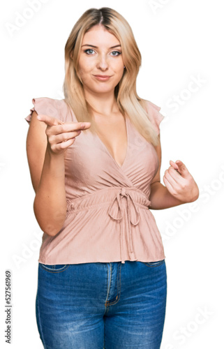 Young caucasian woman wearing casual clothes pointing fingers to camera with happy and funny face. good energy and vibes.