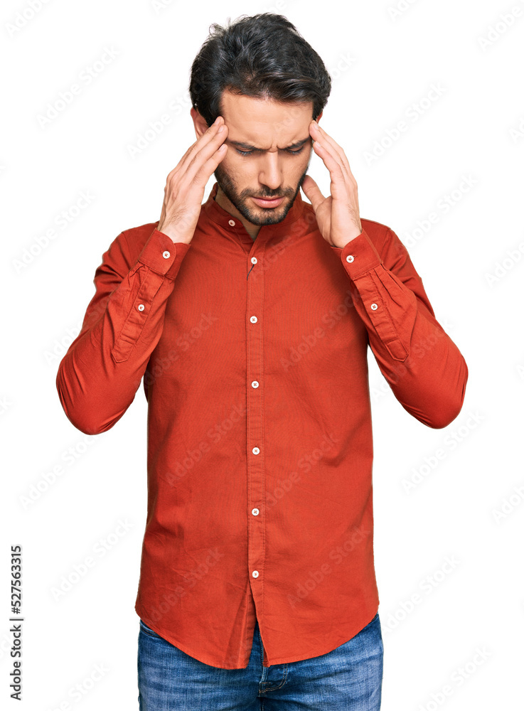 Young hispanic man wearing casual clothes with hand on head for pain in head because stress. suffering migraine. Young hispanic man wearing casual clothes with hand on head for pain in head because stress. suffering migraine.