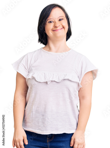 Fototapeta Brunette woman with down syndrome wearing casual white tshirt with a happy and cool smile on face