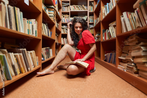 Back to school with attractive librarian in red dress photo