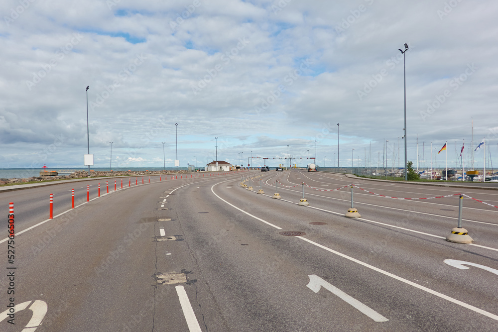 An empty highway near the port terminal. Asphalt road surface marking. Kuivastu harbor, Estonia. Transportation, ferry ship connection, traffic laws, safety concepts