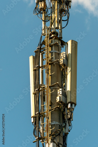 New GSM antennas on a high tower against a blue sky for transmitting a 5g signal are dangerous to health. Radiation pollution of the environment through cell towers. The threat of extinction