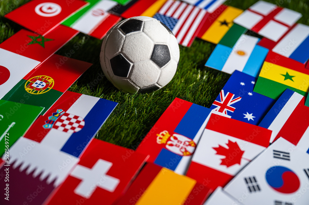Football Ball And Flags Of All 32 Countries Which Will Play In Qatar 