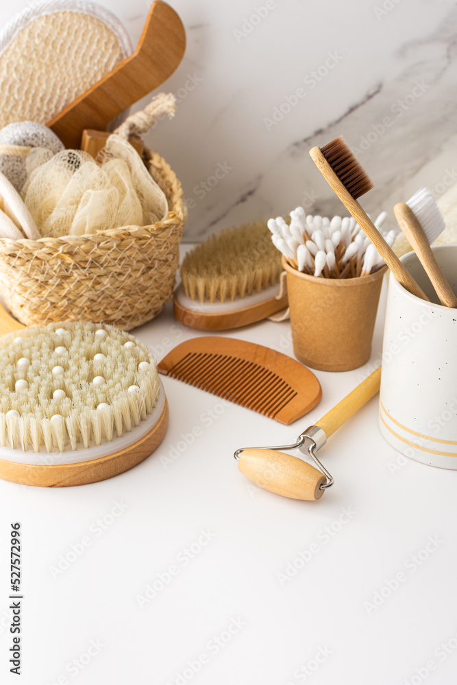 Wooden toothbrushes with natural bristles in a ceramic glass, face and skin care products, bath accessories, spa and beauty concept Wooden toothbrushes with natural bristles in a ceramic glass, face and skin care products, bath accessories, spa and beauty concept
