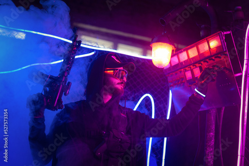 Sci fi special agent with the gun in the neon lights concept.