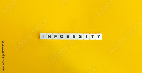 Infobesity (Information Overload) Banner. Block Letter Tiles on Yellow Background. Minimal Aesthetics. photo