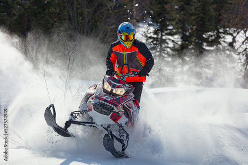 Snowmobile riding with fun in deep snow powder during backcountry tour. Extreme sport adventure, outdoor activity during winter holiday on ski mountain resort © Wlad Go