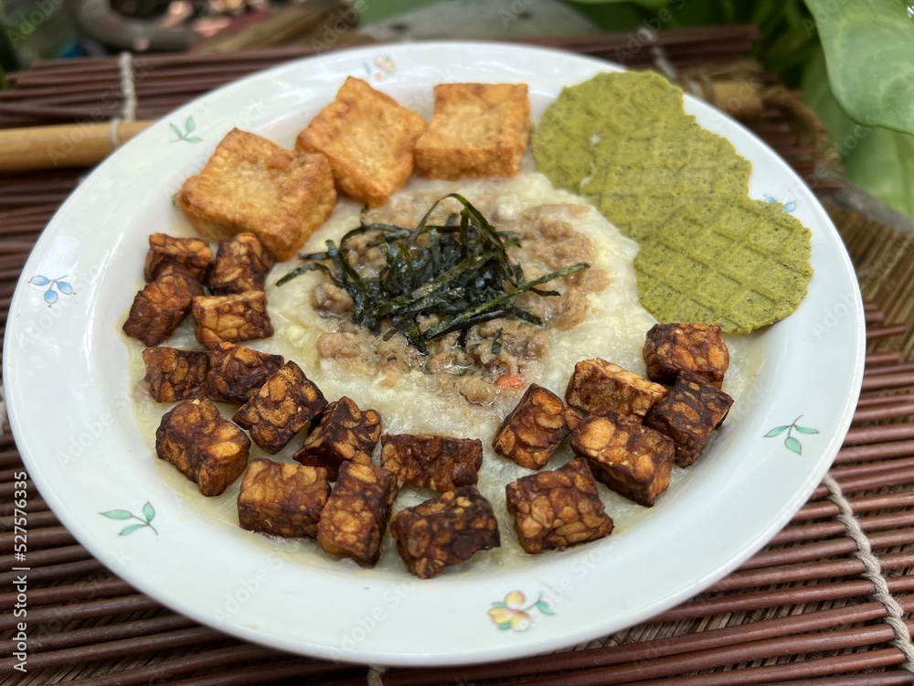 Congee with fried tempeh and stir pork and fried tofu Congee with fried tempeh and stir pork and fried tofu