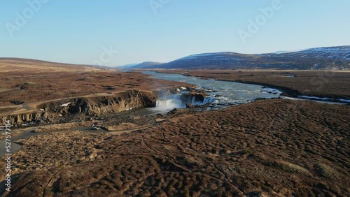 Icelandic river and waterfall with mountains on the background drone show in 4K