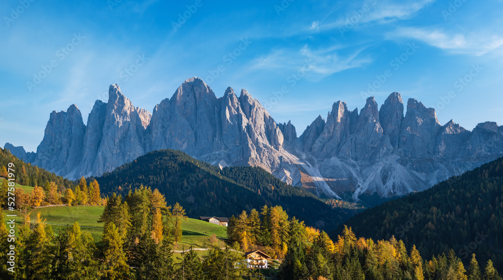 Autumn evening Santa Magdalena famous Italy Dolomites village surroundings in front of the Geisler or Odle Dolomites mountain rocks. Picturesque traveling and countryside beauty concept background.