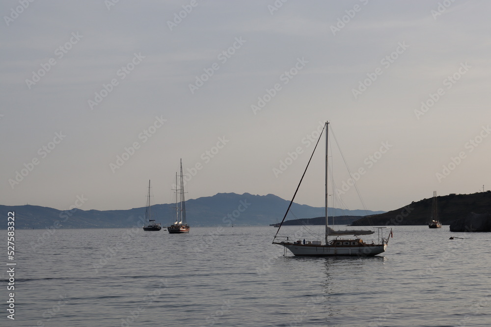 Evening, boats moored on the beach and calm sea. Evening, boats moored on the beach and calm sea.